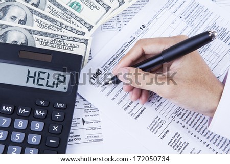 Hands of accountant filling the tax forms