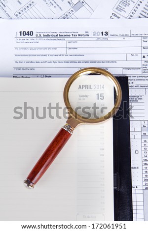 Close up of financial documents with magnifier