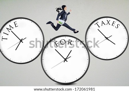 Businesswoman running over the clocks with time for taxes