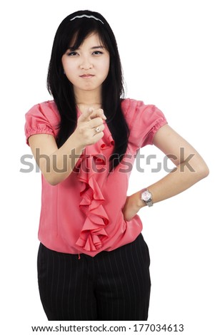 Very angry businesswoman point her finger to camera, isolated on white