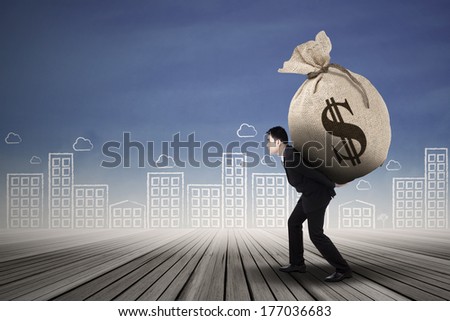 Businessman carrying a money sack with US dollar sign outdoor
