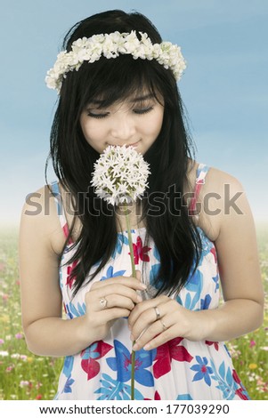 Beautiful woman with crown of flower holding flower