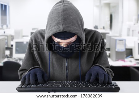 Computer hacker - Male thief stealing data from computer