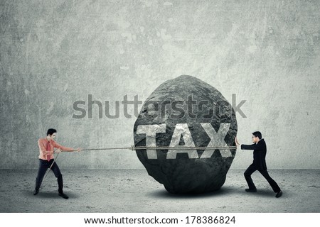 Portrait of young business teamwork try to move the big stone as a big obstacle
