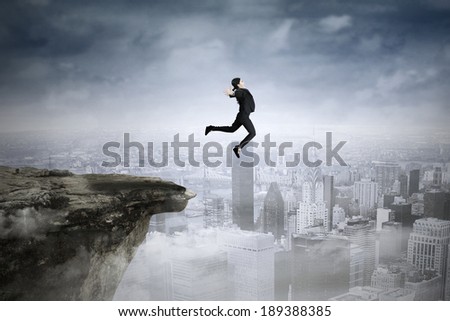 Successful asian businesswoman jumping against city background