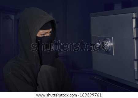 Portrait of confused robber thinking the lock code