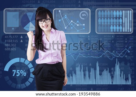 Successful young business woman happy for her success in front of futuristic interface