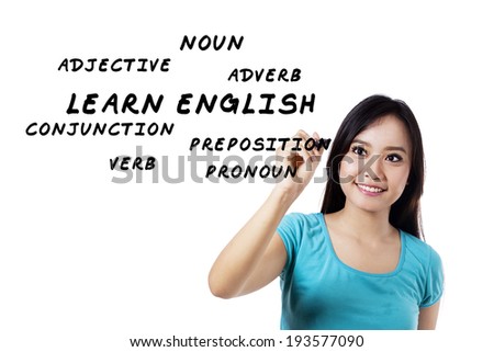 Female student writes english language materials on whiteboard
