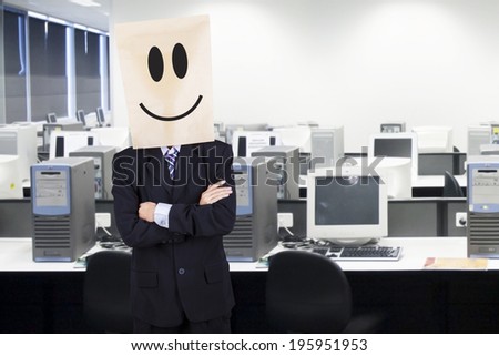 Businessman with cardboard head smiling. Shoot in the office