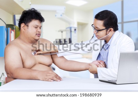 Doctor is checking a fat man. shoot in the hospital