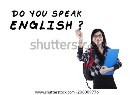 Learning language concept. Female student write Do You Speak English?