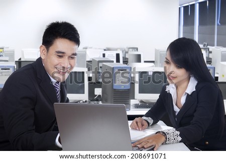 Business team is having a meeting in office using laptop