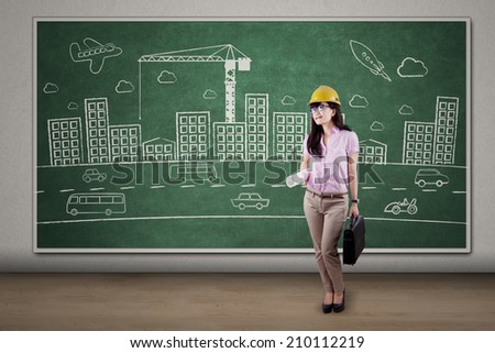 Successful engineer standing in front of project design