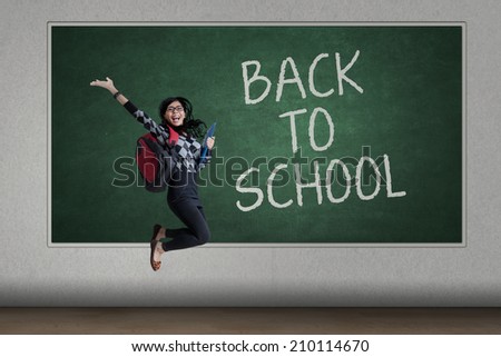 Happy student back to school and jumping at the class