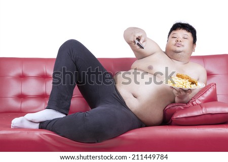 stock-photo-fat-man-eats-fast-food-while-watching-tv-at-home-211449784.jpg
