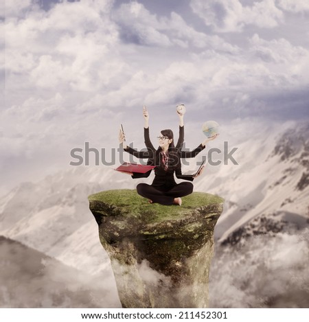 Businesswoman is juggling many tasks on top of a mountain