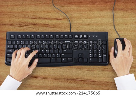 Closeup of businessman hand typing on keyboard with mouse