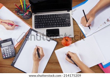Unique Perspectives of hands of student group studying together on a desk