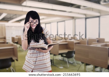 Young asian college student reading book in the reading room