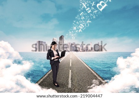 Business woman standing on the road and use laptop to send email