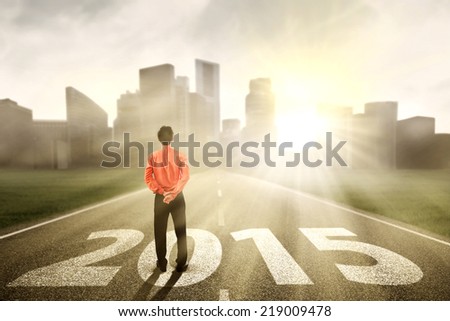 Businessman standing on the road and looking ahead in 2015