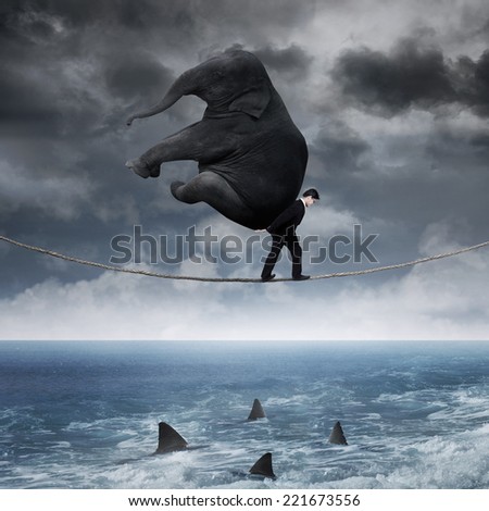 Business person carrying an elephant and walk on the rope above sea