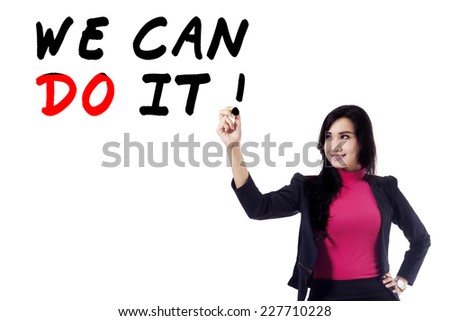 Portrait of businesswoman give motivation by writing motivation word on whiteboard