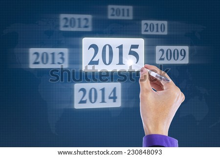 Closeup of hand working with stylus and pressing number 2015 on the virtual button