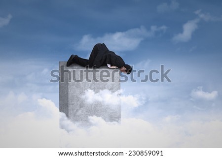 Young male entrepreneur bending on the top of bar and looking down