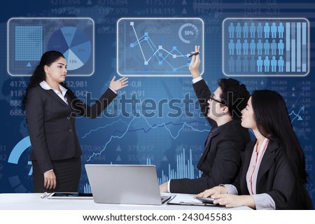 Male employee raising hand and inquiring on his manager when meeting together in the office