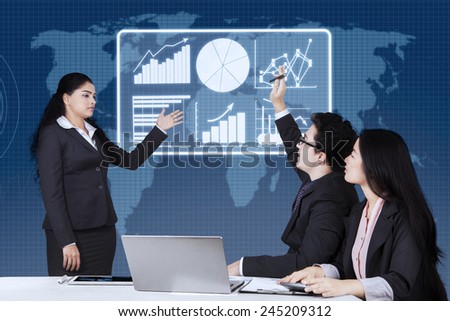 Portrait of male worker raising hand and enquiring on his leader in a business meeting at the office