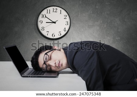 Tired caucasian businessman in business suit work overtime and sleep on laptop