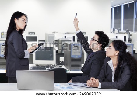 Young businesswoman lead a business meeting in the office room with two partners