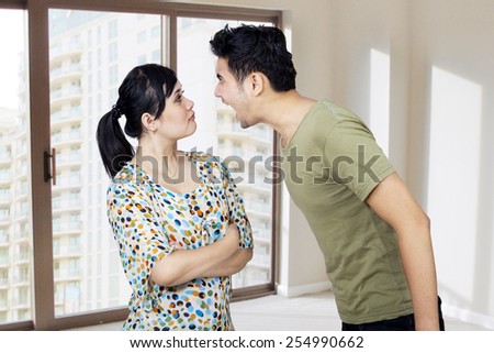Young man and woman fighting in a home