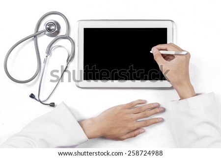 Closeup of general doctor hands using stylus pen to touch the digital tablet screen