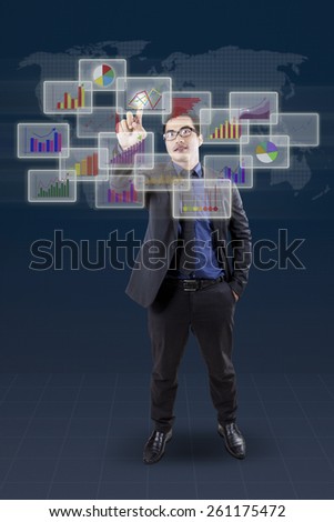 Successful male banker using modern futuristic screen interface to manage financial chart