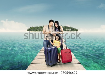 Group of happy family traveling together and look at a digital map on the tablet