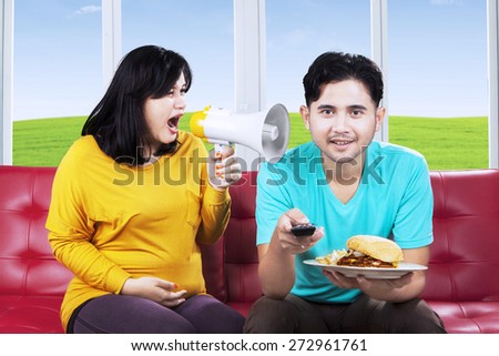Angry wife and shouting at her husband at home