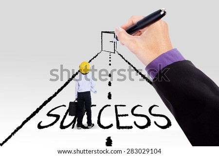 Little engineer standing on a road with a success text and a hand drawing a door at the end of the road
