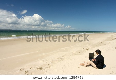 Businesswoman with business suit working at the beach
