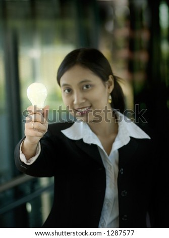 Businesswoman holding a lightbulb (symbolizing an idea)