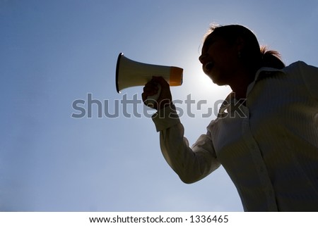 Silhouette of woman shouting with a megaphone