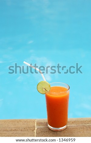 Mixed fruit juice for breakfast shot by the swimming pool