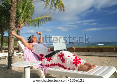 Asian businesswoman working on her vacation at the beach