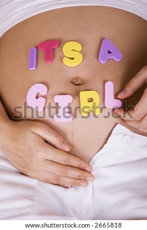Pregnant woman showing off her belly with her unborn daughter (vertical)