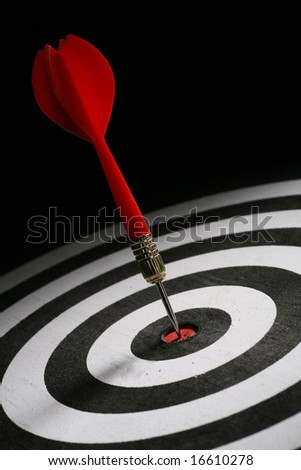 Portrait shot of a Red dart on bull\'s eye of a dart board