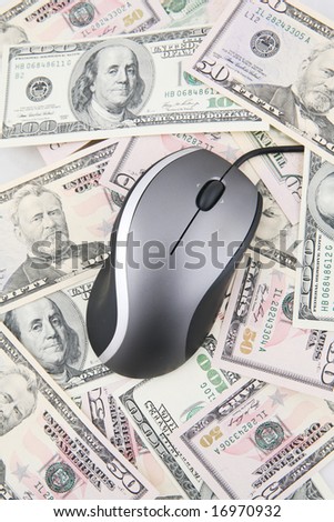 Computer mouse over hundred and fifty US Dollars bills