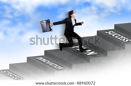 Young Asian businessman running carrying a laptop bag