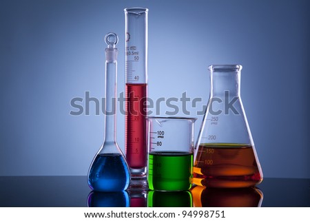Many different colored chemical solutions in laboratory glasses