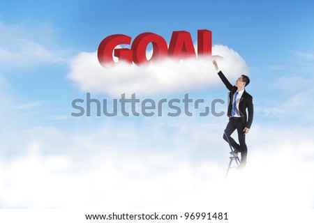 Businessman climbing ladder to set his goal high